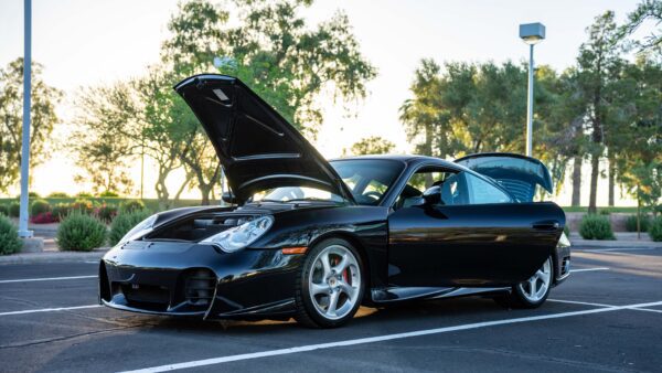 Black Porsche Turbo Coupe with Doors Opened Side View